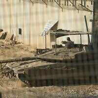 Israeli soldiers cross with a tank from southern Lebanon into northern Israel, June 18, 2026. (AP Photo/Ariel Schalit)