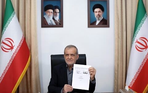Iranian President Masoud Pezeshkian displays a memorandum of understanding signed with US President Donald Trump, in Tehran, Iran, early on June 18, 2026. (Iranian Presidency Office via AP)