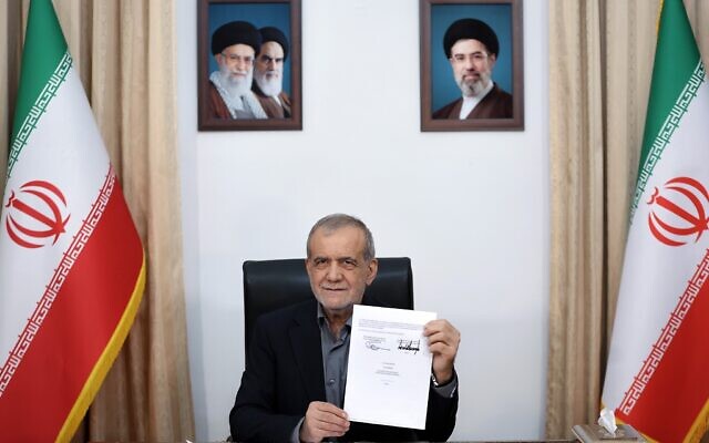 Iranian President Masoud Pezeshkian displays a memorandum of understanding signed with US President Donald Trump, in Tehran, Iran, early on June 18, 2026. (Iranian Presidency Office via AP)
