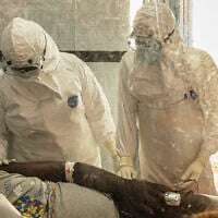 Health workers attend to an Ebola patient at the Rwampara treatment Center in Ituri, Congo, June 18, 2026. (AP Photo/Moses Sawasawa)