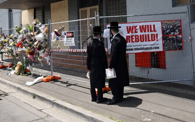 People gather outside the Adass Israel Synagogue, December 9, 2024, after a firebombing in Melbourne, Australia. (Con Chronis/AAP Image via AP) People gather outside the Adass Israel Synagogue, December 9, 2024, after a firebombing in Melbourne, Australia. (Con Chronis/AAP Image via AP)