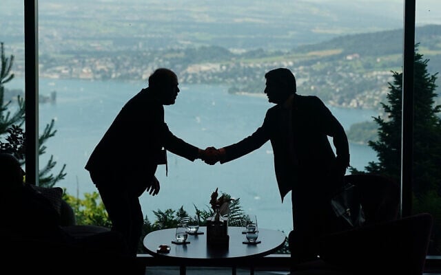 Delegation staff members meet in the lobby on the first day of a quadrilateral meeting between the US, Iran, Pakistan, and Qatar at the Buergenstock Resort Lake Lucerne, near Stansstad, Switzerland, June 21, 2026. (Nathan Howard/Pool Photo via AP) Delegation staff members meet in the lobby on the first day of a quadrilateral meeting between the US, Iran, Pakistan, and Qatar at the Buergenstock Resort Lake Lucerne, near Stansstad, Switzerland, June 21, 2026. (Nathan Howard/Pool Photo via AP)