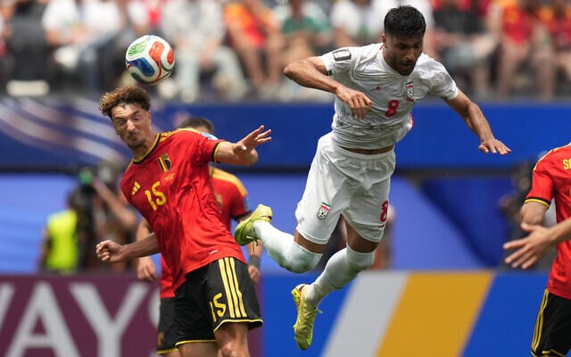 Belgium's Thomas Meunier, left, heads the ball past Iran's Mohammad Mohebbi during the World Cup Group G soccer match between Belgium and Iran in Inglewood, California, near Los Angeles, June 21, 2026. (AP/Andre Penner)