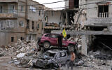 People check destroyed cars following a ceasefire between Israel and Hezbollah in the village of Maifadoun, southern Lebanon, June 22, 2026. (AP Photo/Mohammed Zaatari)