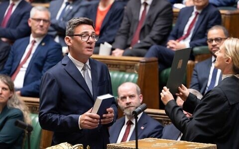 Andy Burnham, front left, is sworn-in as an MP in the House of Common in London, England, June 22, 2026. (House of Commons via AP)