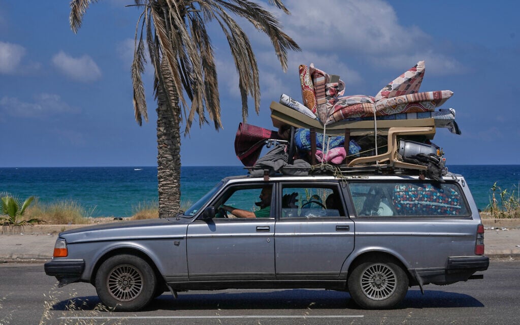 A displaced family with their belongings, return to their village following a ceasefire between Israel and Hezbollah in the southern port city of Sidon, Lebanon, June 23, 2026. (AP Photo/Mohammed Zaatari)