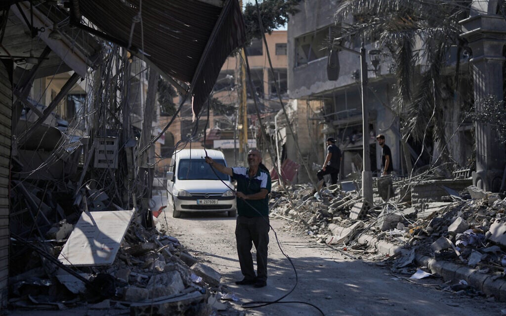 People inspect their shops destroyed in previous Israeli airstrikes in the town of Nabatiyeh, southern Lebanon, June 24, 2026, after a ceasefire between Israel and Hezbollah. (AP Photo/Bilal Hussein)