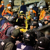 Rescue workers search through the rubble of a collapsed building after two earthquakes in Caracas, Venezuela, June 24, 2026. (AP Photo/Ariana Cubillos)