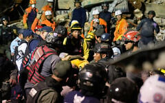 Rescue workers search through the rubble of a collapsed building after two earthquakes in Caracas, Venezuela, June 24, 2026. (AP Photo/Ariana Cubillos)