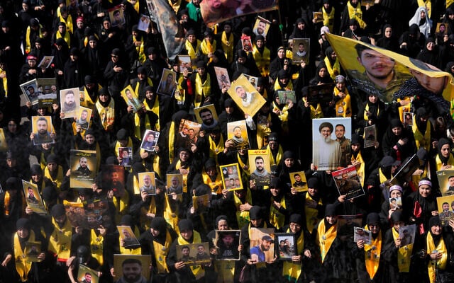 Hezbollah supporters hold portraits of killed Hezbollah fighters, as they march during the holy day of Ashura that commemorates the 7th century martyrdom of the Prophet Muhammad's grandson Hussein, in Dahiyeh, Beirut's southern suburbs, Lebanon, on June 26, 2026. (AP Photo/Hussein Malla)