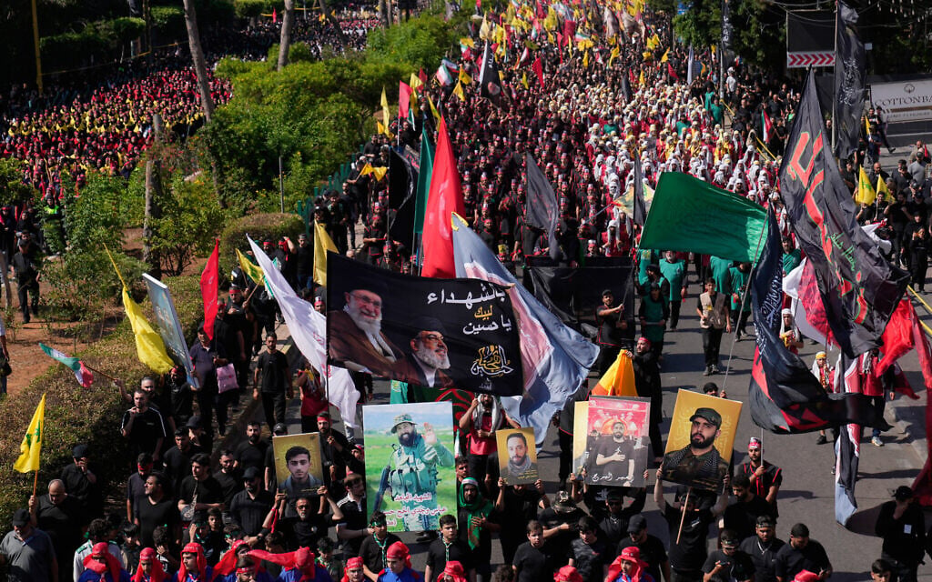 Hezbollah supporters march during the holy day of Ashoura that commemorates the 7th century martyrdom of the Prophet Muhammad's grandson Hussein, in Dahiyeh, Beirut's southern suburbs, Lebanon, June 26, 2026. (Hussein Malla/AP)