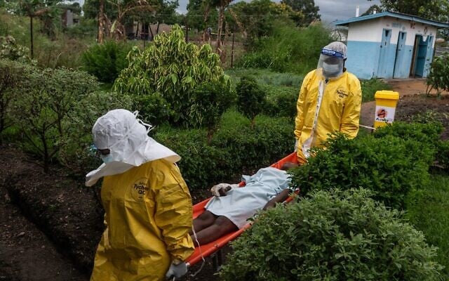 File: Medical staff carry an Ebola patient to a treatment center in Rwampara, Congo, Thursday, May 21, 2026. (AP Photo/Moses Sawasawa, file)