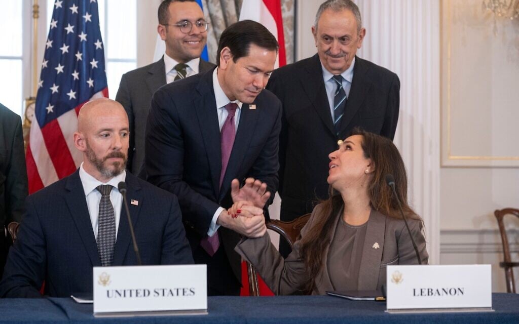 US Secretary of State Marco Rubio shakes hands with Lebanon's Ambassador to the US Nada Hamadeh, left, following a signing of a framework agreement at the State Department, Friday, June 26, 2026, in Washington. At left, is Counselor Dan Holler. (AP Photo/Kevin Wolf)