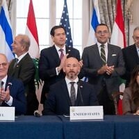 Officials applaud following a trilateral framework signing ceremony at the US State Department with Secretary of State Marco Rubio, top center, and, seated from left, Israel's Ambassador to the US Yechiel Leiter, counselor Dan Holler and Lebanon's Ambassador to the US Nada Hamadeh on Friday, June 26, 2026, in Washington. (AP Photo/Kevin Wolf)