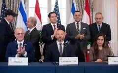 Officials applaud following a trilateral framework signing ceremony at the US State Department with Secretary of State Marco Rubio, top center, and, seated from left, Israel's Ambassador to the US Yechiel Leiter, counselor Dan Holler and Lebanon's Ambassador to the US Nada Hamadeh on Friday, June 26, 2026, in Washington. (AP Photo/Kevin Wolf)