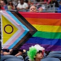 A spectator holds up a Progress Pride flag before the start of the World Cup Group G soccer match between Egypt and Iran in Seattle, Washington, June 26, 2026. (AP Photo//Lindsey Wasson)