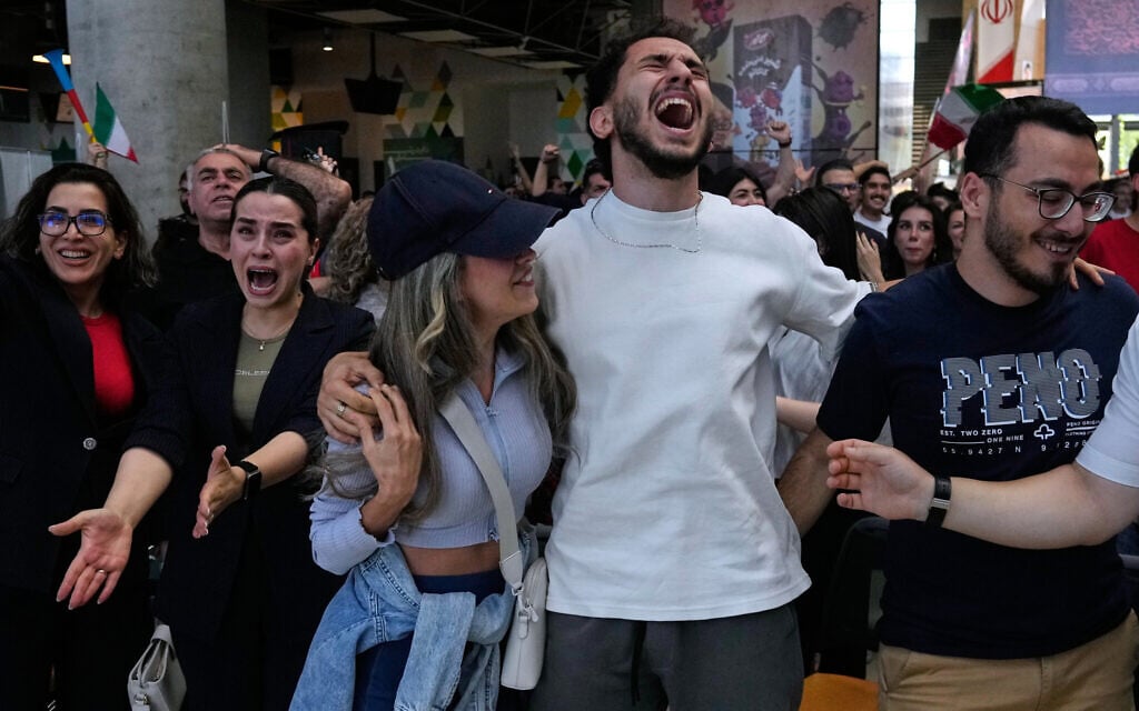Iranian fans react while watching a live broadcast of Iran's World Cup Group G match against Egypt at the Book Garden bookstore converted into a World Cup viewing venue in Tehran, Iran, June 27, 2026. (AP Photo/Vahid Salemi)