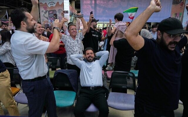 Iranian fans react after Iran appeared to score against Egypt, before the goal was later disallowed by VAR, at a World Cup viewing venue in Tehran, Iran, June 27, 2026. (AP Photo/Vahid Salemi)