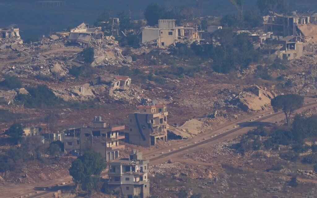 An Israeli flag, center, on a destroyed building in southern Lebanon is seen from northern Israel, on June 28, 2026. (AP Photo/Ohad Zwigenberg)