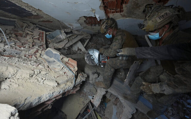 Rescuers make their way through the rubble in search of earthquake survivors in La Guaira, Venezuela, June 28, 2026. (AP/Matias Delacroix)
