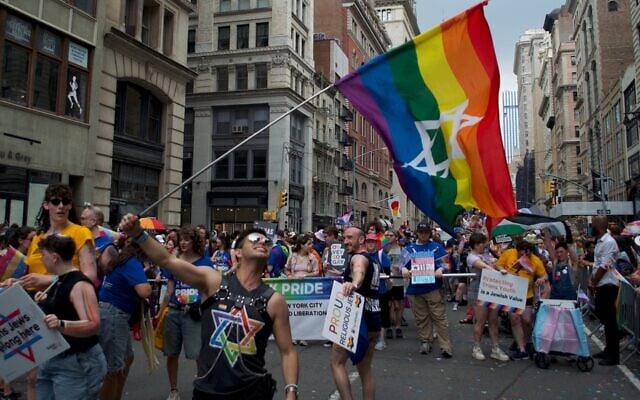 Dillon Perez waves a Jewish pride flag at the New York City Pride March on June 29, 2026. (Grace Gilson/ JTA)