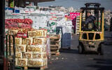 A Palestinian worker on a forklift at the wholesale produce market in Jerusalem's Givat Shaul neighborhood, November 25, 2015. (Hadas Parush/Flash90)