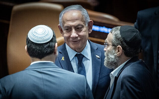 Prime Minister Benjamin Netanyahu (C) and UTJ MK Moshe Gafni (R) at the assembly hall of the Knesset, in Jerusalem on March 19, 2025. (Yonatan Sindel/Flash90)