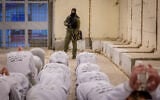 Israel Prison Service officers prepare Palestinian prisoners for release as part of a hostage deal between Israel and Hamas, at Ketziot Prison in southern Israel, February 26, 2025. (Chaim Goldberg/Flash90)