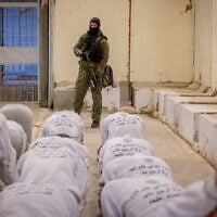 Israel Prison Service officers prepare Palestinian prisoners for release as part of a hostage deal between Israel and Hamas, at Ketziot Prison in southern Israel, February 26, 2025. (Chaim Goldberg/Flash90)