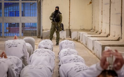 Israel Prison Service officers prepare Palestinian prisoners for release as part of a hostage deal between Israel and Hamas, at Ketziot Prison in southern Israel, February 26, 2025. (Chaim Goldberg/Flash90)