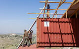 A temporary housing unit being built from shipping containers at the Chavat Meir La’Aretz outpost in the West Bank, March 12, 2026. (Dor Pazuelo/Flash90)