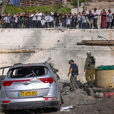 Civilians and security forces at the scene where a missile fired by Hezbollah from Lebanon struck a parking area in Safed, causing heavy damage, April 10, 2026. (David Cohen/Flash90) Civilians and security forces at the scene where a missile fired by Hezbollah from Lebanon struck a parking area in Safed, causing heavy damage, April 10, 2026. (David Cohen/Flash90)