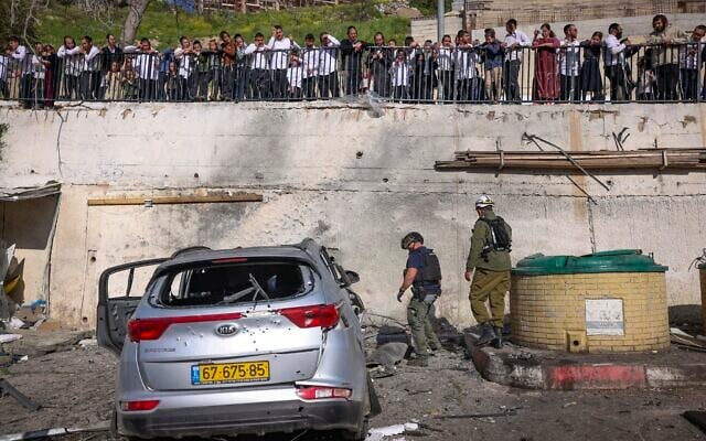 Civilians and security forces at the scene where a missile fired by Hezbollah from Lebanon struck a parking area in Safed, causing heavy damage, April 10, 2026. (David Cohen/Flash90) Civilians and security forces at the scene where a missile fired by Hezbollah from Lebanon struck a parking area in Safed, causing heavy damage, April 10, 2026. (David Cohen/Flash90)