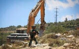 Illustrative: Israeli security forces guard while bulldozers demolish a home in the town of Nahalin, West Bank, May 25, 2026. (Wisam Hashlamoun/Flash90)