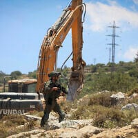 Illustrative: Israeli security forces guard while bulldozers demolish a home in the town of Nahalin, West Bank, May 25, 2026. (Wisam Hashlamoun/Flash90)