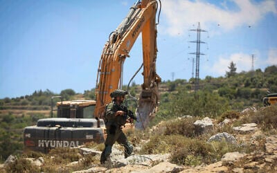 Illustrative: Israeli security forces guard while bulldozers demolish a home in the town of Nahalin, West Bank, May 25, 2026. (Wisam Hashlamoun/Flash90)