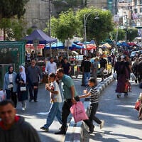 Palestinians shop at a market ahead of the Eid al-Adha festival, in the West Bank city of Hebron, on May 26, 2026. (Wisam Hashlamoun/Flash90)