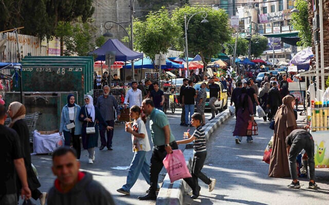 Palestinians shop at a market ahead of the Eid al-Adha festival, in the West Bank city of Hebron, on May 26, 2026. (Wisam Hashlamoun/Flash90) Palestinians shop at a market ahead of the Eid al-Adha festival, in the West Bank city of Hebron, on May 26, 2026. (Wisam Hashlamoun/Flash90)