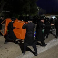 Haredi demonstrators push over a dumpster while rioting outside the home of Supreme Court Deputy Chief Justice Noam Sohlberg in the settlement of Alon Shvut, June 3, 2026. (Chaim Goldberg/Flash90)