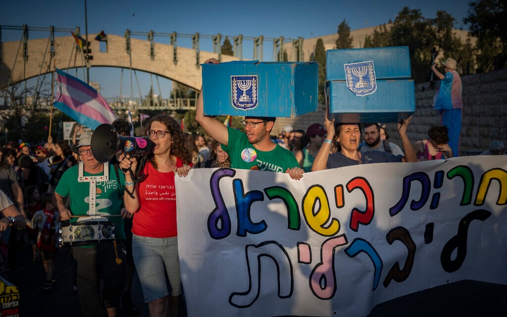 Marchers carry faux ballot boxes as thousands take part in the annual Jerusalem Pride Parade outside the Knesset on June 4, 2026. (Yonatan Sindel/Flash90)