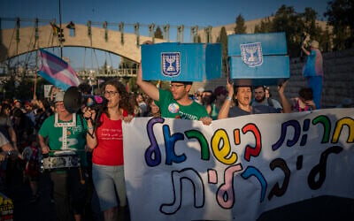 Marchers carry faux ballot boxes as thousands take part in the annual Jerusalem Pride Parade outside the Knesset on June 4, 2026. (Yonatan Sindel/Flash90)