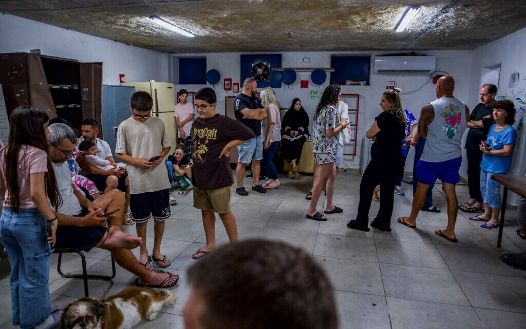 Israelis take cover in a public shelter in the northern Israeli city of Haifa as a siren sounds warning of incoming Iranian missiles, June 7, 2026. (Sharon Leibel/Flash90)
