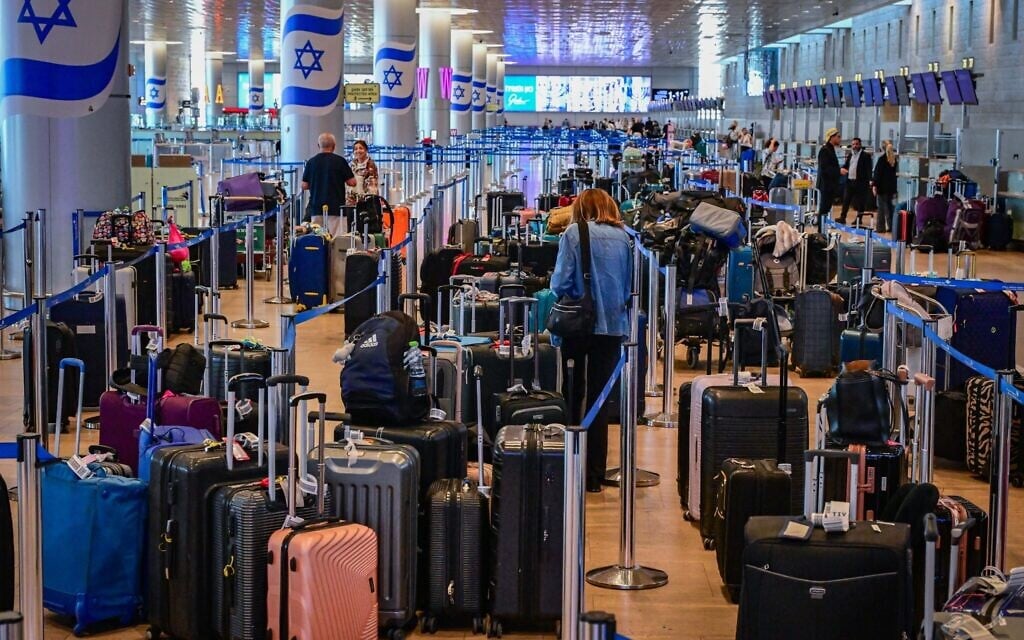 Passengers at Ben Gurion Airport near Tel Aviv during an Iranian missile attack, June 8, 2026 (Avshalom Sassoni/Flash90)