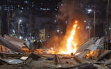 Ultra-Orthodox Jewish protesters set fire to construction materials during a protest against work on the Jerusalem Light Rail in the Bar-Ilan area of Jerusalem, June 8, 2026 (Chaim Goldberg/Flash90)