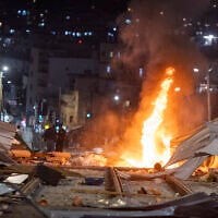 Ultra-Orthodox Jewish protesters set fire to construction materials during a protest against work on the Jerusalem Light Rail in the Bar-Ilan area of Jerusalem, June 8, 2026 (Chaim Goldberg/Flash90)