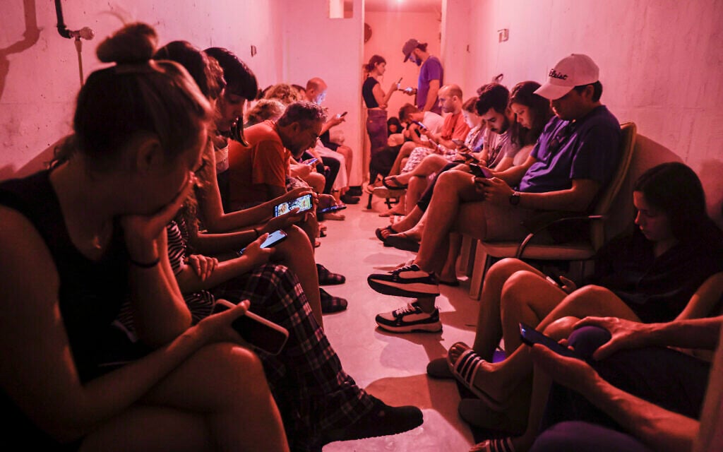 People in Tel Aviv take cover in a bomb shelter from incoming missiles fired from Iran, June 8, 2026 (Yehoshua Yosef/Flash90)
