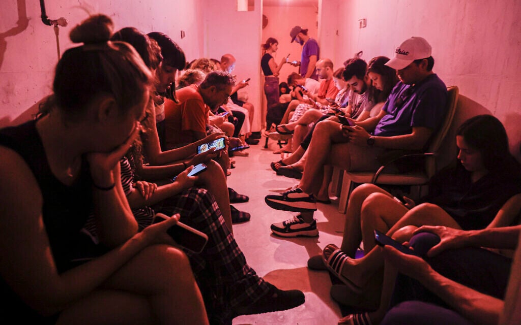 People in Tel Aviv take cover in a bomb shelter during an Iranian missile attack on June 8, 2026. (Yehoshua Yosef/Flash90)