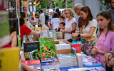 People visit the opening of the 100th Hebrew Book Week at Sarona in Tel Aviv, June 10, 2026. (Avshalom Sassoni/Flash90)