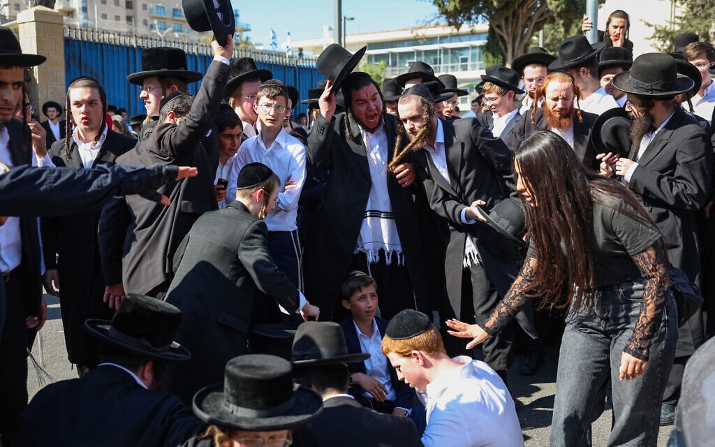 Ultra-Orthodox protesters demonstrate against the arrest of ultra-Orthodox men who took part in a riot outside the home of Supreme Court Justice Noam Sohlberg and were later handed over to the military police, outside the police station in Jerusalem, June 10, 2026. (Noam Revkin Fenton/Flash90)