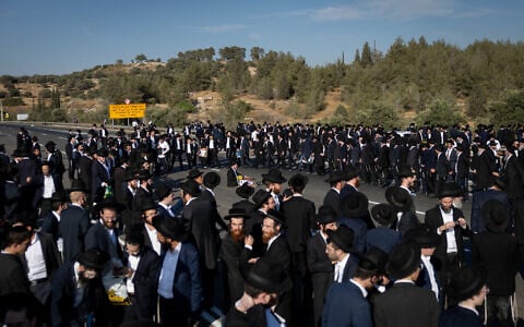 Ultra-Orthodox men block a highway between Jerusalem and Tel Aviv, on June 11, 2026. (Yonatan Sindel/Flash90)